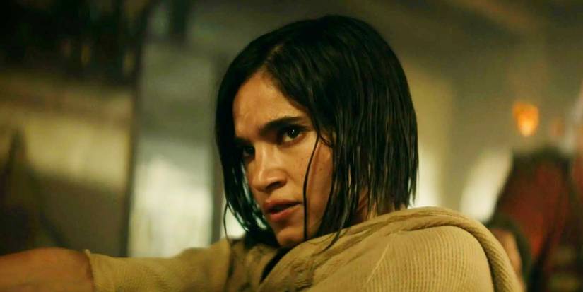 Sofia Boutella wielding a pistol as Kora in Rebel Moon Part One A Child of Fire