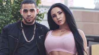 Sophie Sierra In 90 Day Fiance wearing pink crop top with black hair standing next to Rob Warne in black outfit