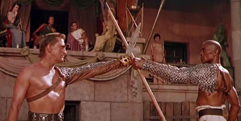 Kirk Douglas as Spartacus holding his weapon up to another gladiator's weapon in the movie Spartacus