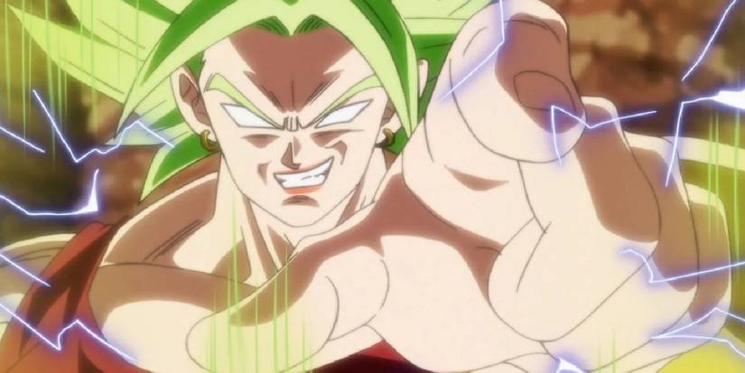 Super Saiyan Berserk Kale smirks and points at the viewer as energy crackles around her in Dragon Ball Super.