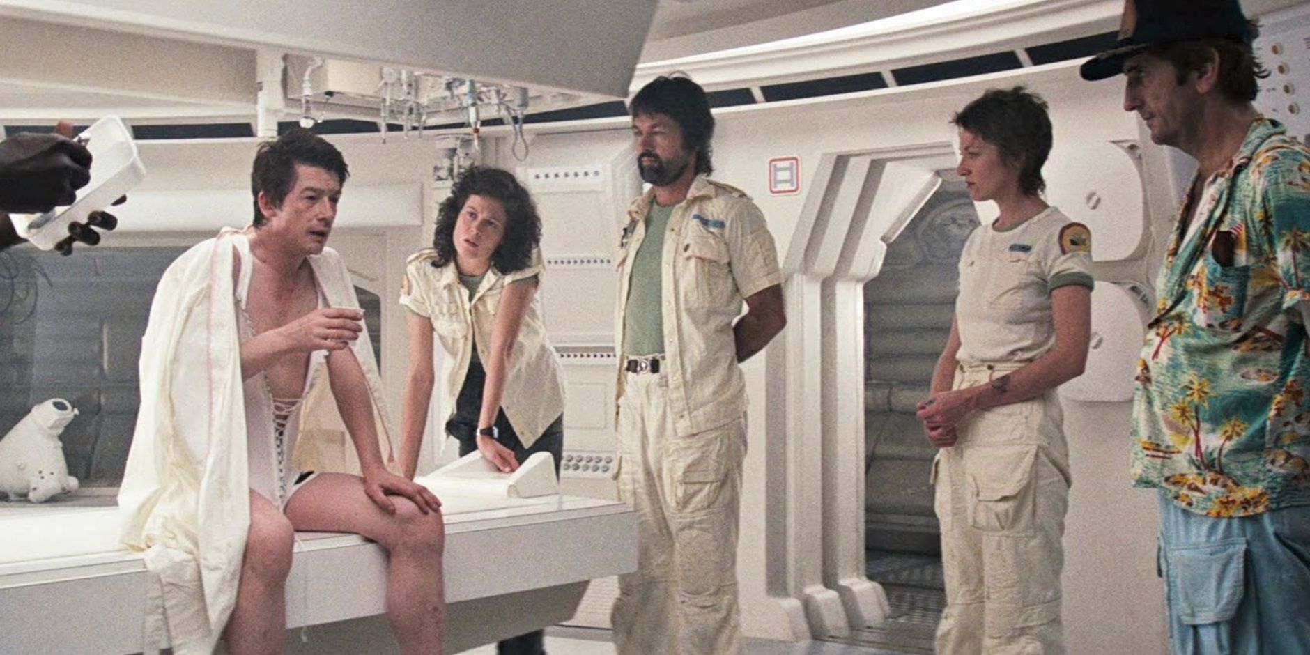 The crew of the Nostromo gathered around Kane in Alien