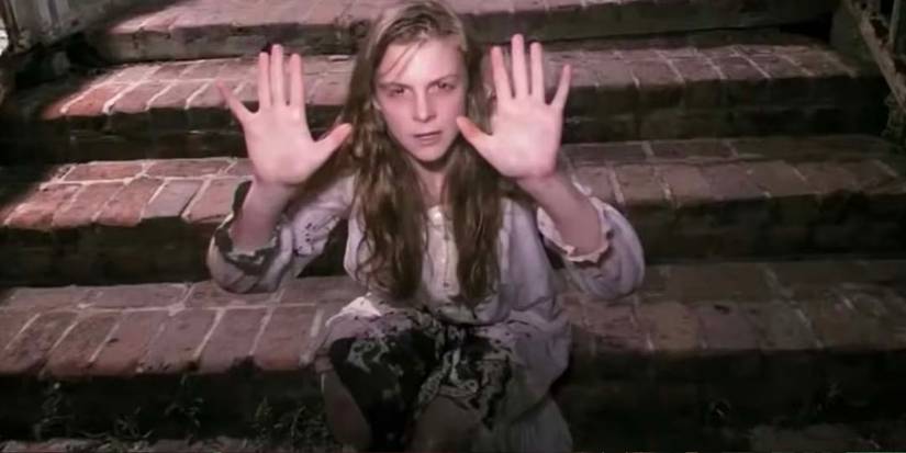 Ashley Bell as Nell holding her hands up in The Last Exorcism.