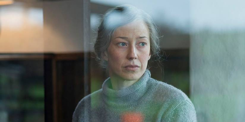 Nora (Carrie Coon) wears a somber expression while looking out the window in The Leftover series finale