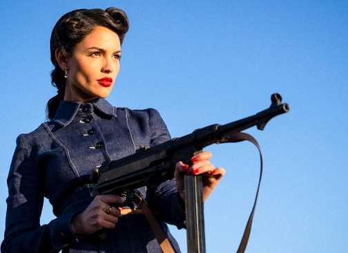 Eiza González as Marjorie Stewart holding an assault rifle in The Ministry of Ungentlemanly Warfare