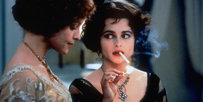 Kate looking at Milly while smoking a cigarette in  The Wings of the Dove (1997) 