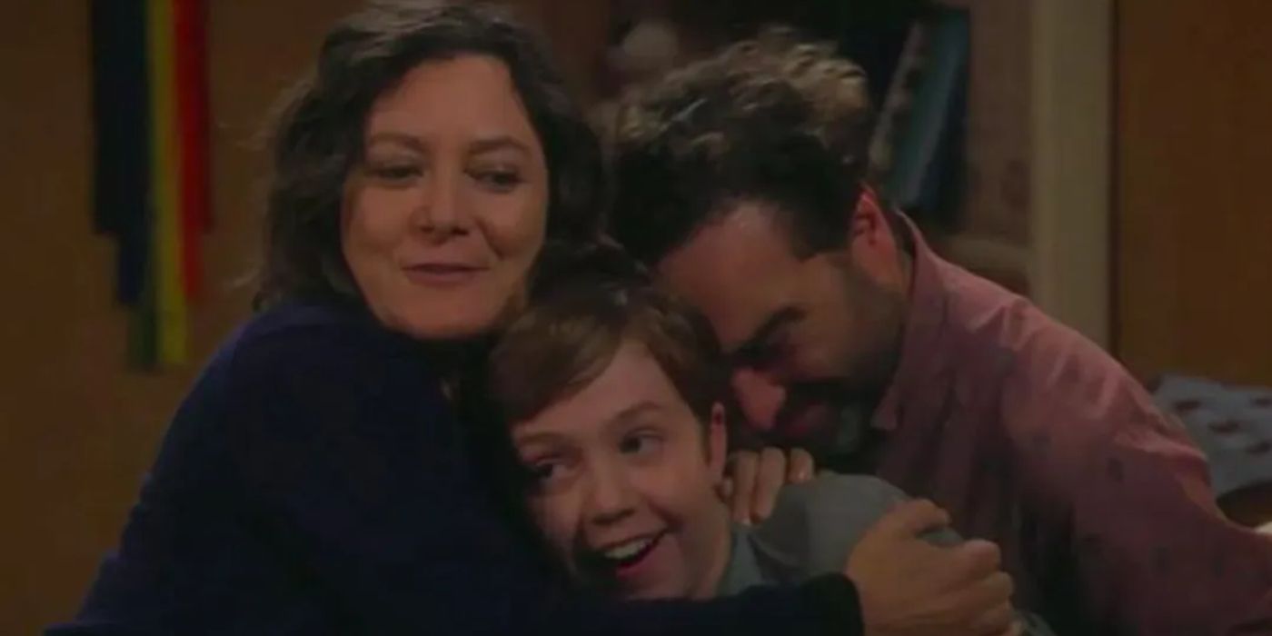 Mark being hugged by his parents Darlene and David in The Conners