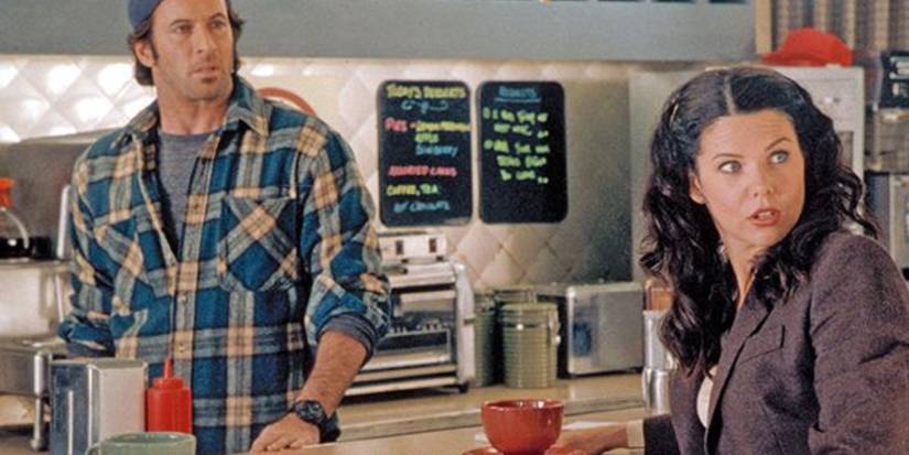 Lorelai having coffee at the Diner with Luke behind the counter in Gilmore Girls