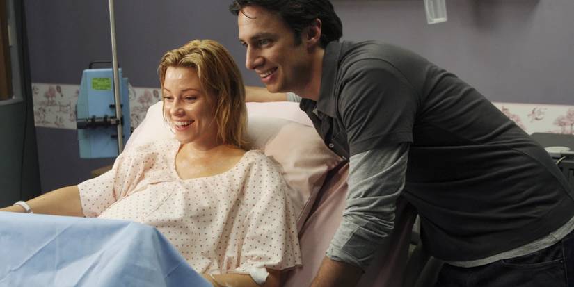J.D. standing by an exhausted Kim in a hospital bed, as she is in labor with Sammy, in Scrubs.