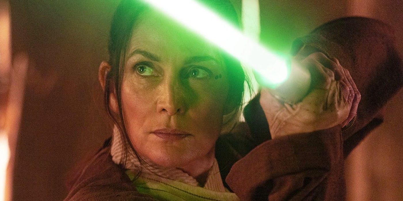 Carrie-Anne Moss as Indara in The Acolyte wielding her green lightsaber 
