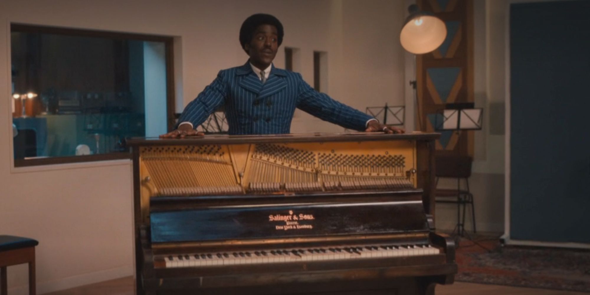 Ncuti Gatwa as the Fifteenth Doctor standing behind a piano in Doctor Who.