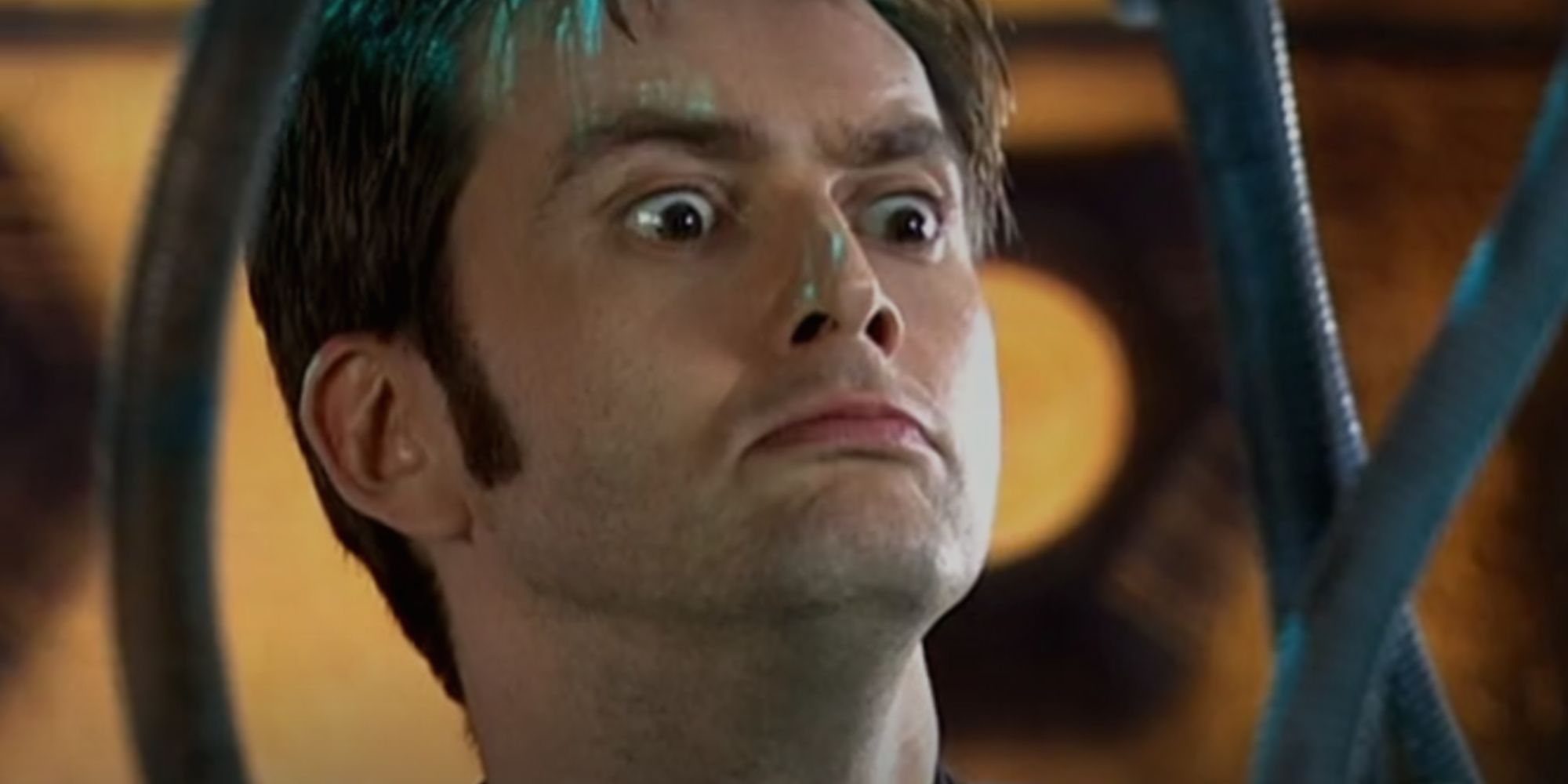 David Tennant as the Tenth Doctor looking intrigued in Doctor Who