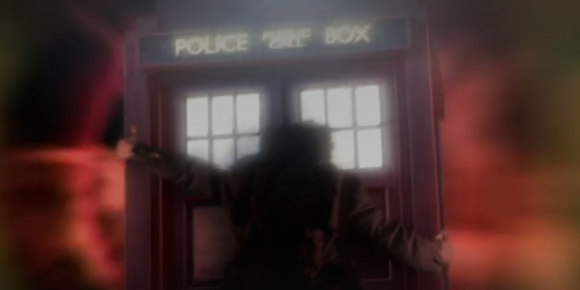Jack Harkness holding onto the outside of the TARDIS as it flies through the time vortex in Doctor Who