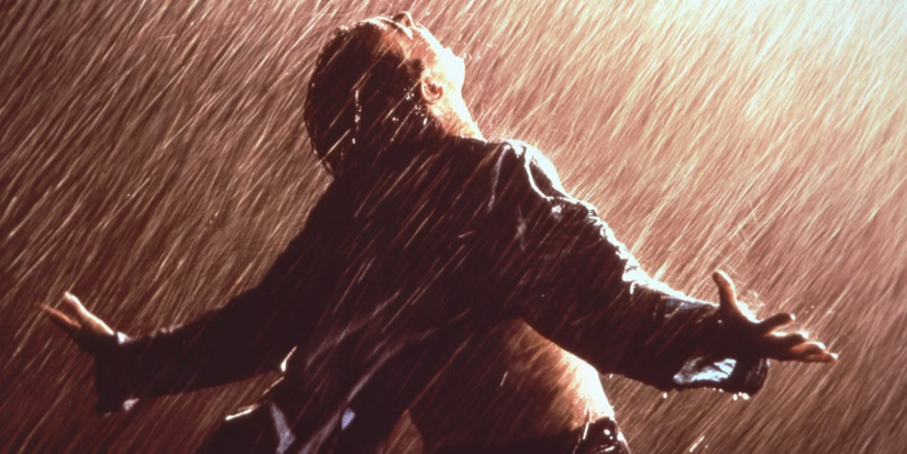 Andy Dufresne taking a rain bath after scaping prison in Shawshank Redemption