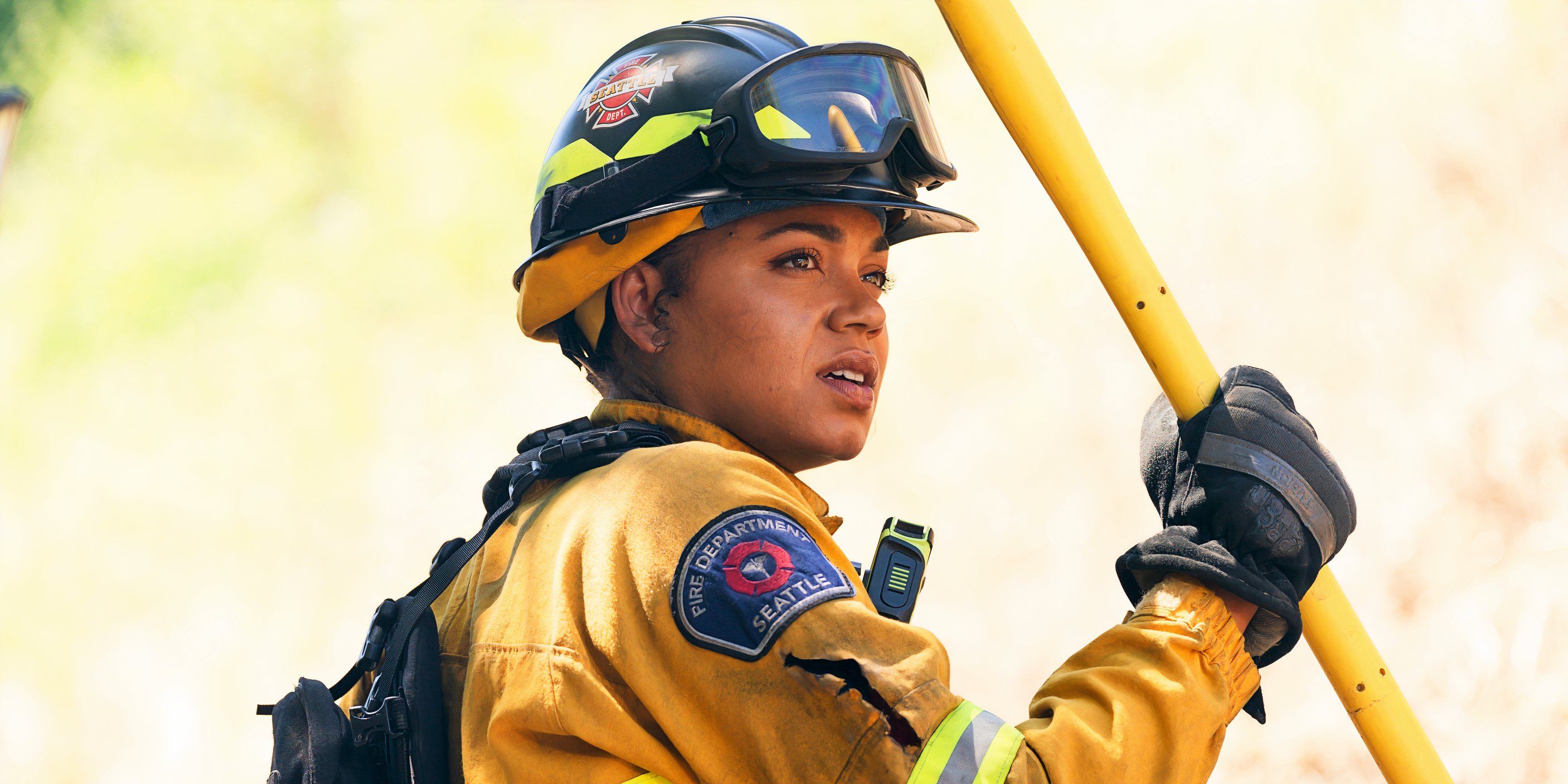 Barrett Doss as Vic holding a pole in her firefighting gear in the Station 19 series finale