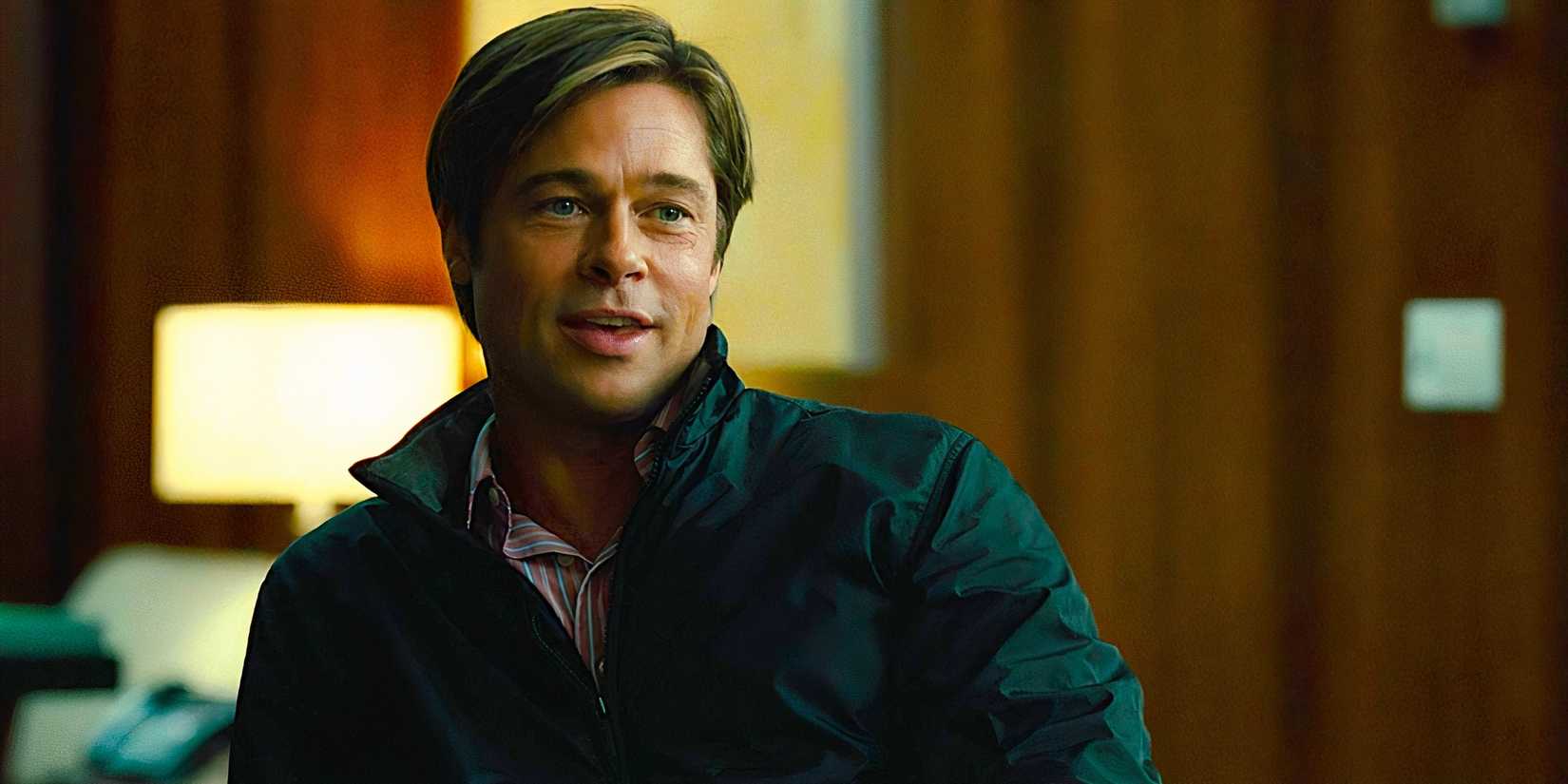 Brad Pitt sitting and politely chatting in a scene from Moneyball