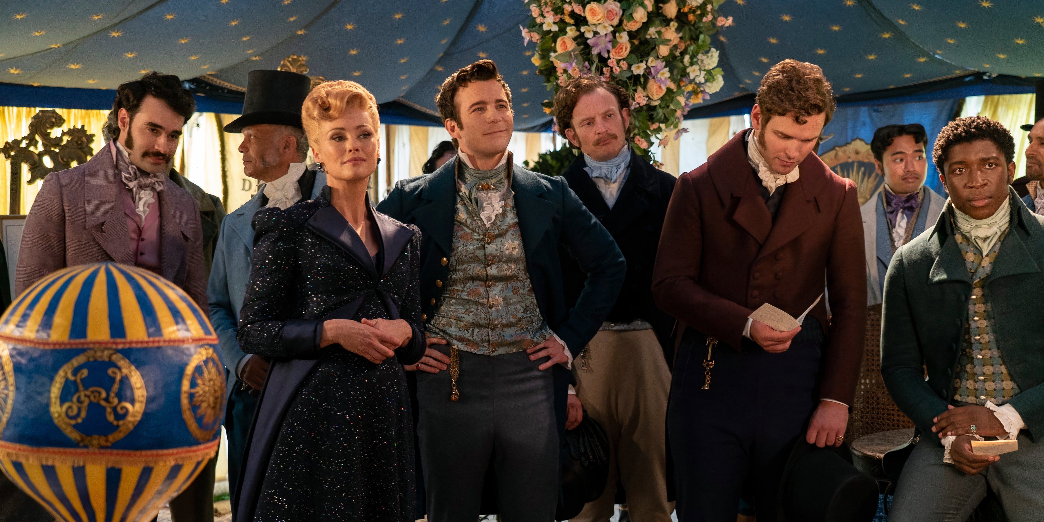 Colin stands with Lady Tilly Arnold and other characters in Bridgerton season 3 still