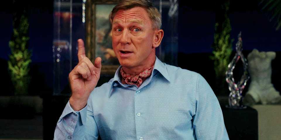 Daniel Craig as Benoit Blanc Holds Up a Finger in Glass Onion A Knives Out Mystery