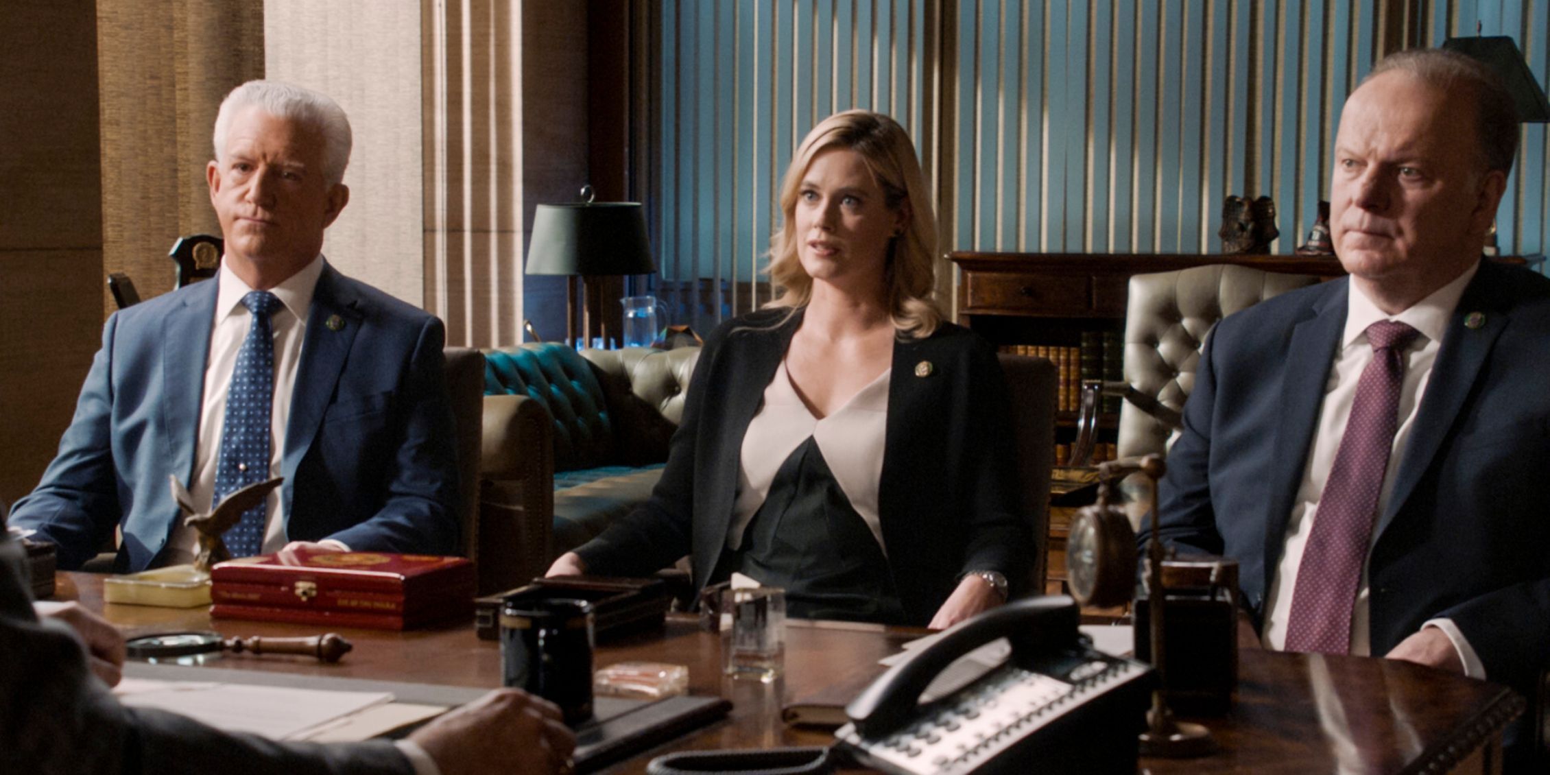 Blue Bloods Frank's Dream Team, consisting of Abigail, Sid, and Garett, sits across from him at a meeting