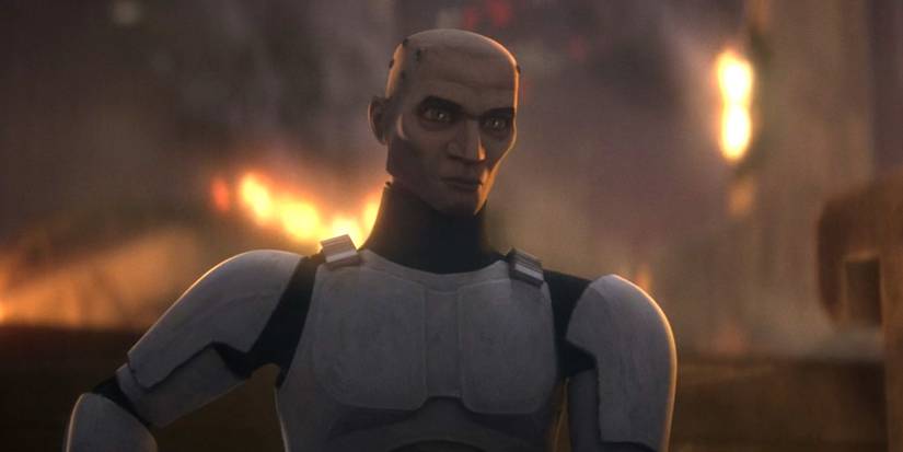 Echo stands with his helmet off in front of a burning pile of rubble on Mount Tantiss in Star Wars: The Bad Batch season 3 finale