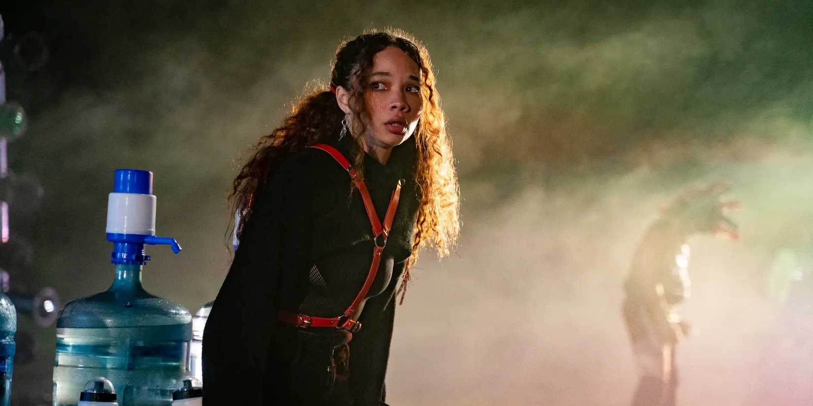 Ash (Ashley Moore) standing next to a water station in Festival of the Living Dead