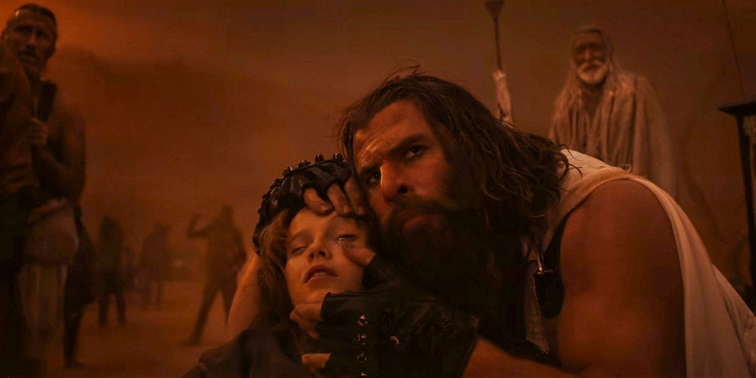 Dr. Dementus (Chris Hemsworth) forcing young Furiosa (Alyla Browne) to open her eyes in Furiosa: A Mad Max Saga