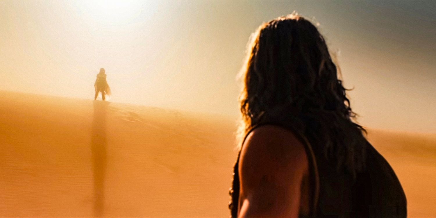 Dr. Dementus (Chris Hemsworth) sees the silhouette of Furiosa appear on the horizon in the middle of a desert in Furiosa: A Mad Max Saga