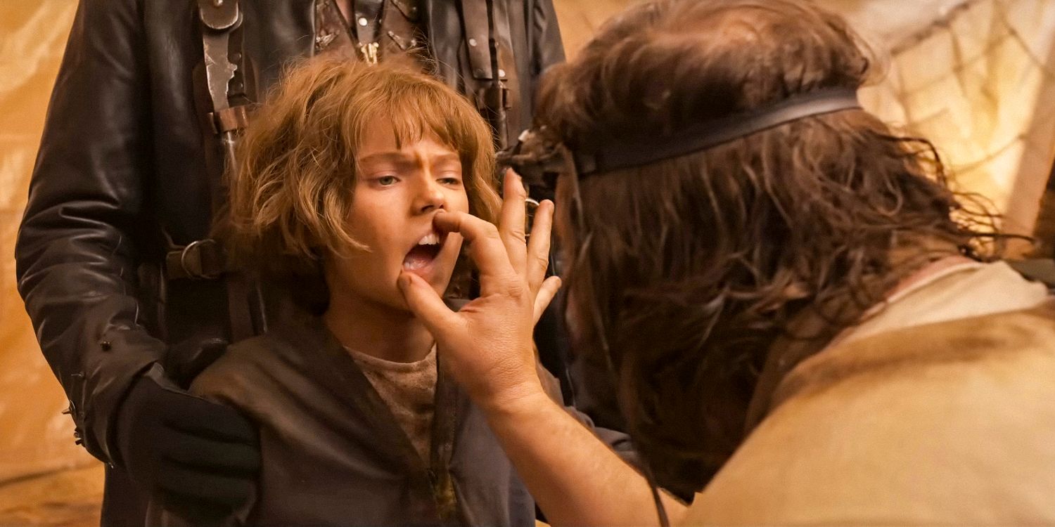 Dr. Dementus examining the teeth of young Furiosa (Alyla Browne) in Furiosa: A Mad Max Saga