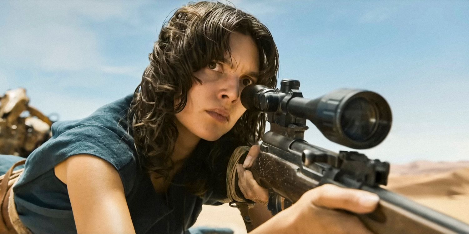 Mary Jabassa (Charlee Fraser) Lying on the Ground Looking Through the Sight of a Rifle in Furiosa a Mad Max Saga