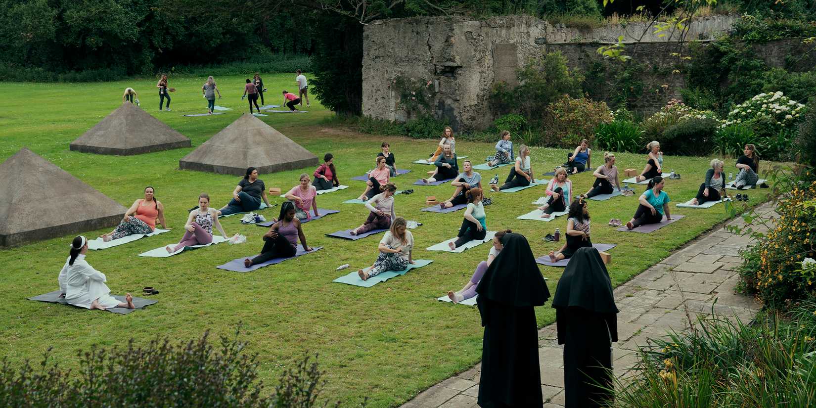 Green Grass with people dong yoga on it in Bodkin