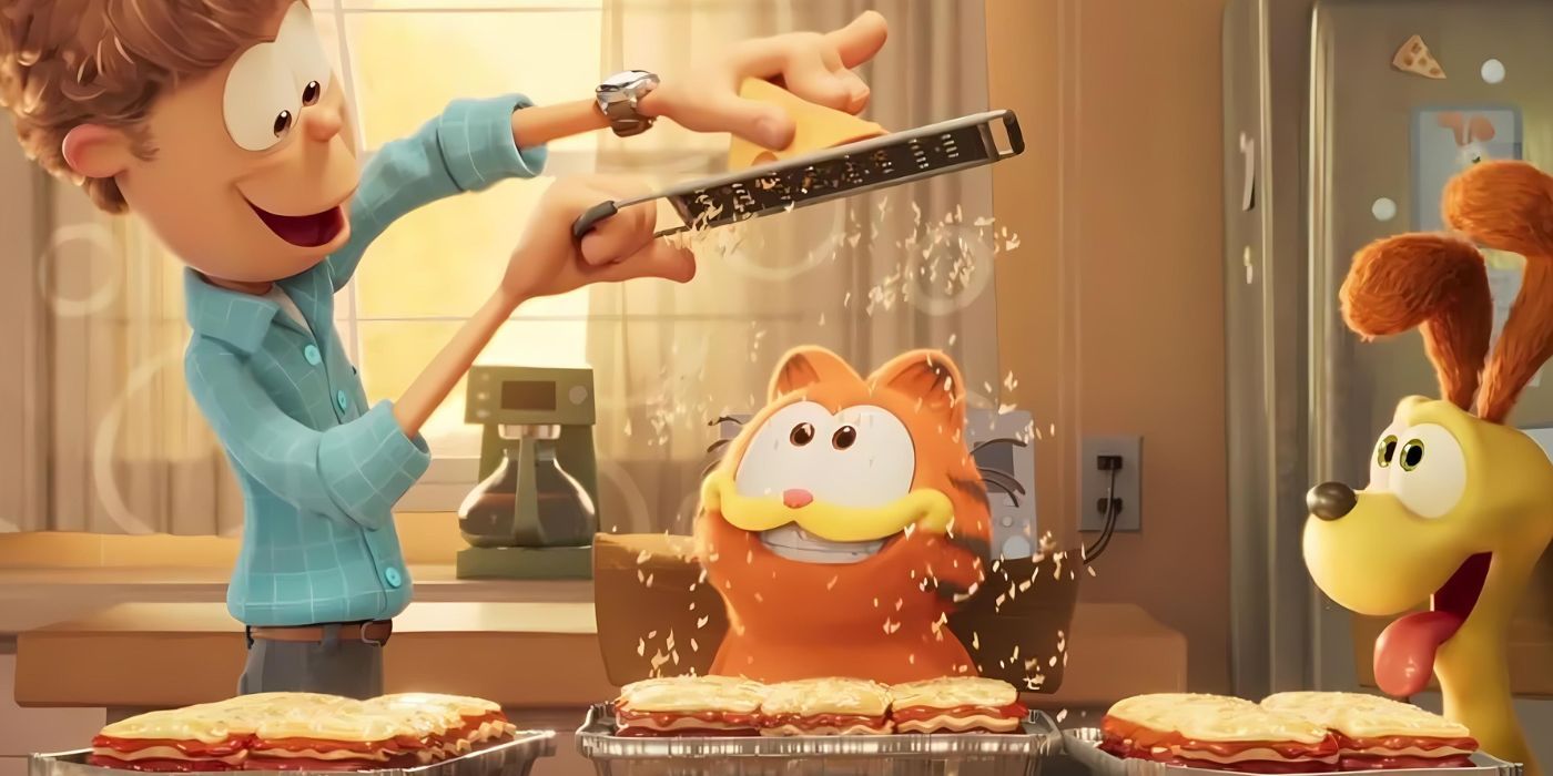 Jon Arbuckle (Nicholas Hoult) grates cheese over a tray of lasagna will Garfield (Chris Pratt) and Odie (Harvey Guillén) smile excitedly in The Garfield Movie