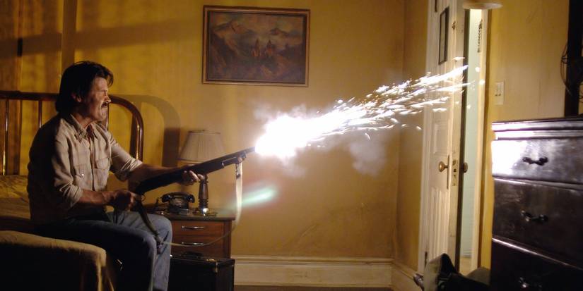 Josh Brolin as Llewelyn Moss firing a shotgun into a door in No Country For Old Men