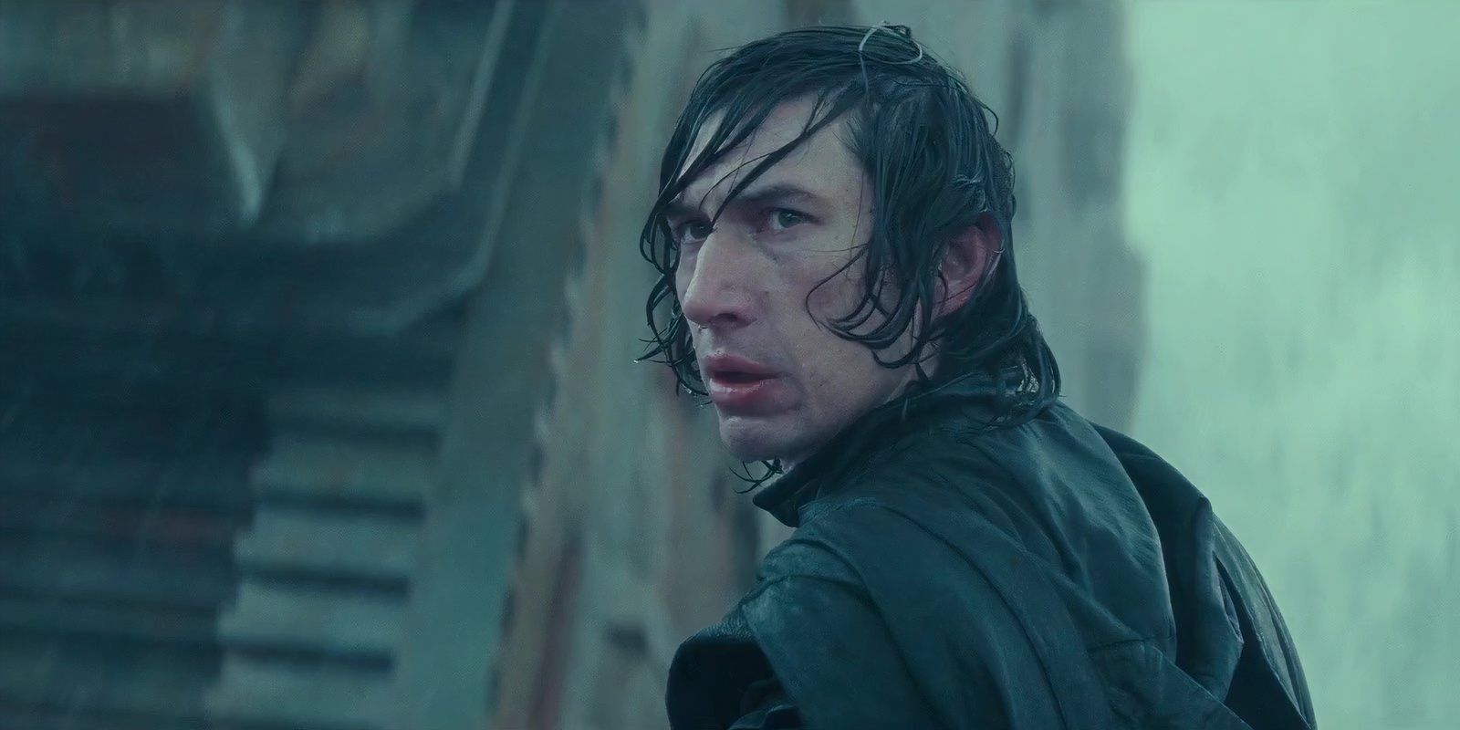 Kylo Ren (Adam Driver) looks over his shoulder in the rain in Star Wars: The Rise of Skywalker