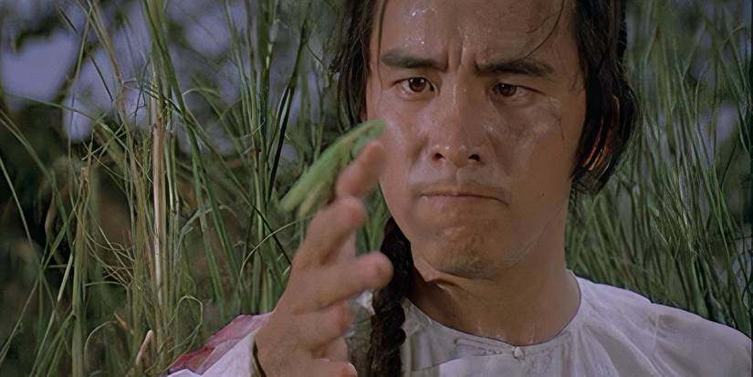 David Chiang as Wei Fung holding a praying mantis in his hand in Shaolin Mantis
