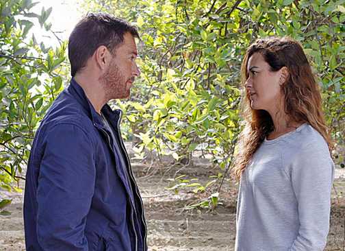 Michael Weatherly as Tony DiNozzo and Cote de Pablo as Ziva David talking outside amid trees in NCIS