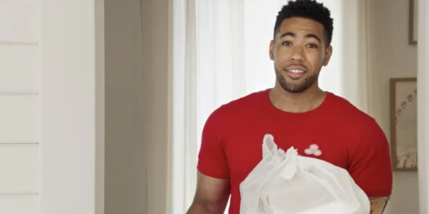 Jake (Kevin Miles) from state farm holding a bag of trash in a commercial