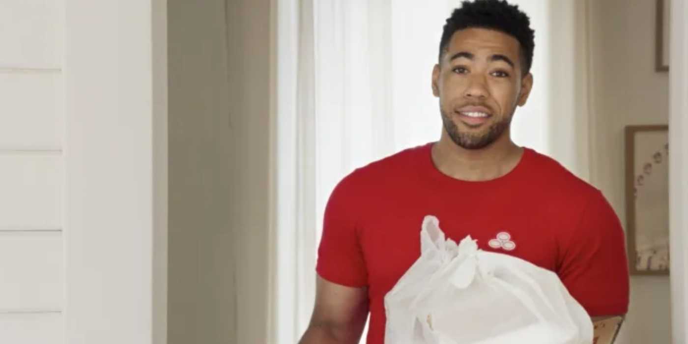 Jake (Kevin Miles) from state farm holding a bag of trash in a commercial