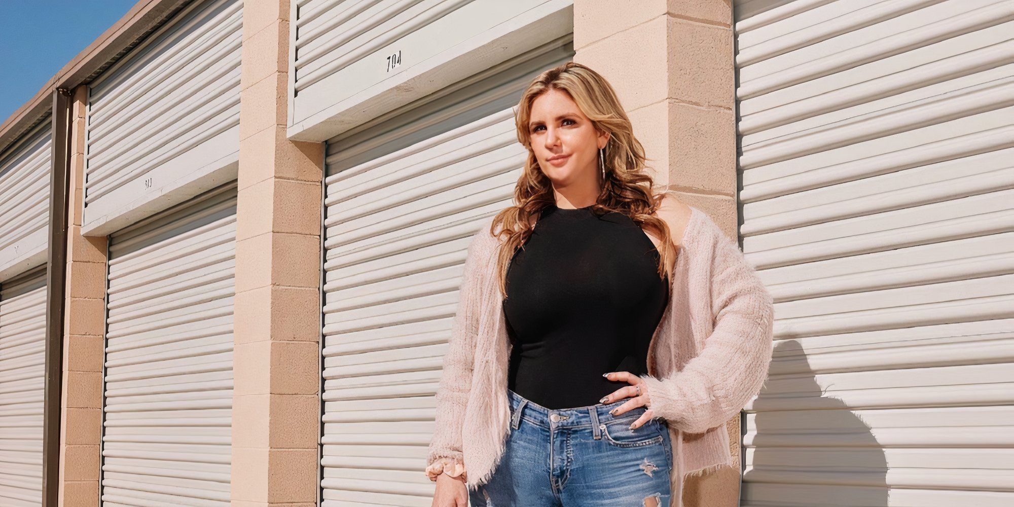 Storage Wars star Brandi Passante posing in front of a storage unit
