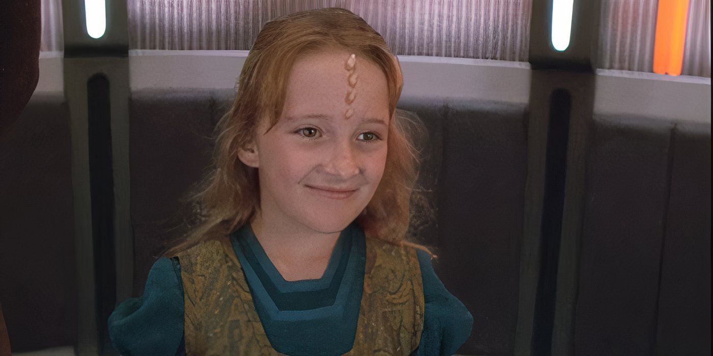 Naomi Wildman stands alone smiling in the turbolift smiling in the Star Trek: Voyager episode "Once Upon a Time"