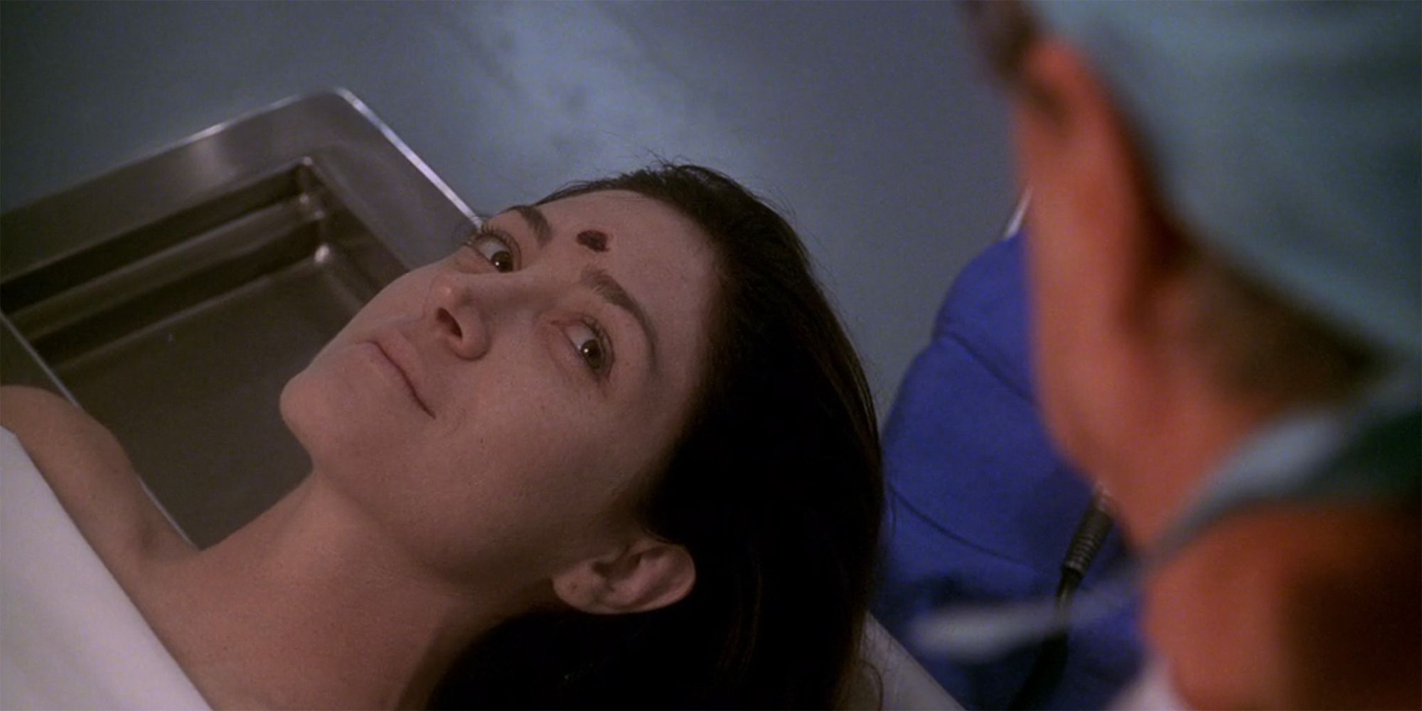 Caitlin Todd in autopsy with a bullet in her head but momentarily animated and smiling in NCIS