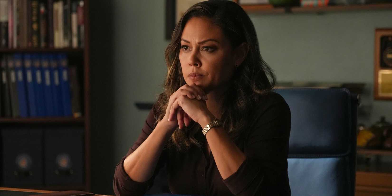 NCIS Hawai'i Jane Tennant looking thoughtful with her hands folded.