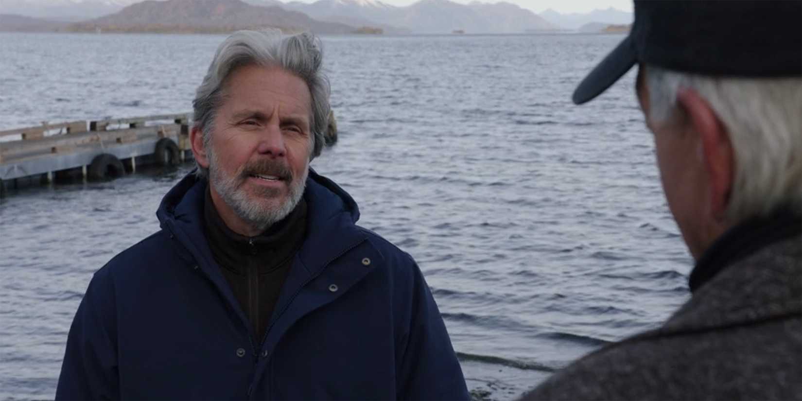 Agent Parker talks to Gibbs while standing on a dock by a large lake in NCIS