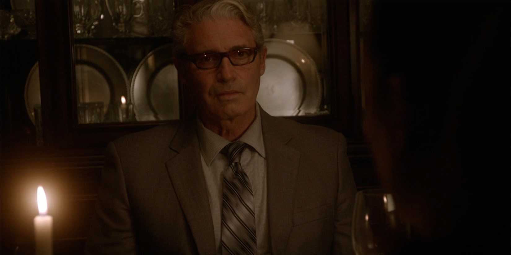 A close up of a candle-lit Eli David in NCIS