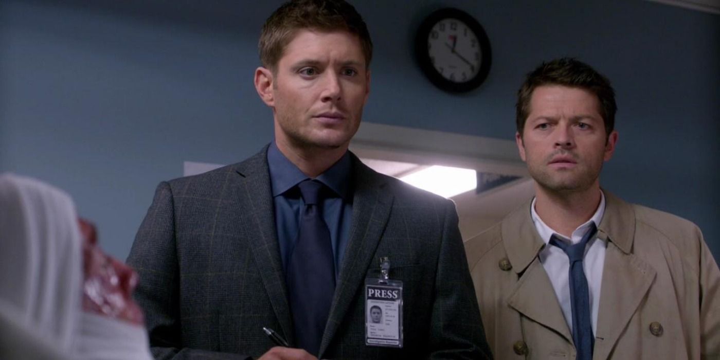 Castiel and Dean Winchester standing next to each other as they look at a patient in Supernatural