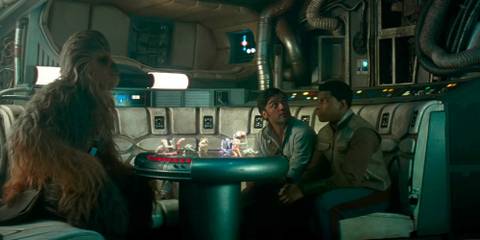 Chewbacca, Poe, and Finn play a game of dejarik on board the Millennium Falcon