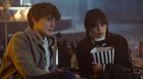 Wednesday and Tyler Galpin watching a movie together.