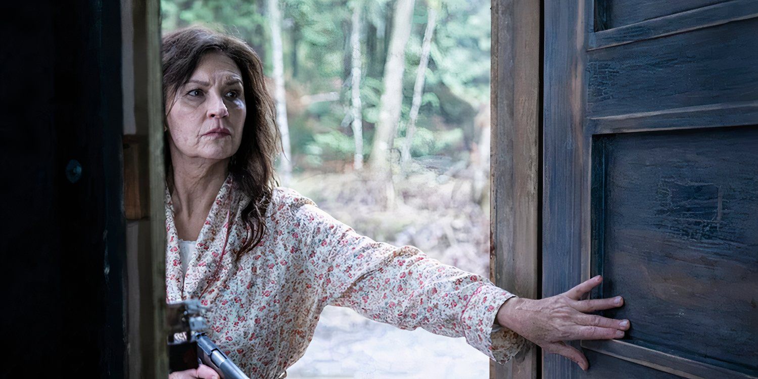 Wendy Crewson as Mary Dove Shaw opening a door and holding a gun in Tracker