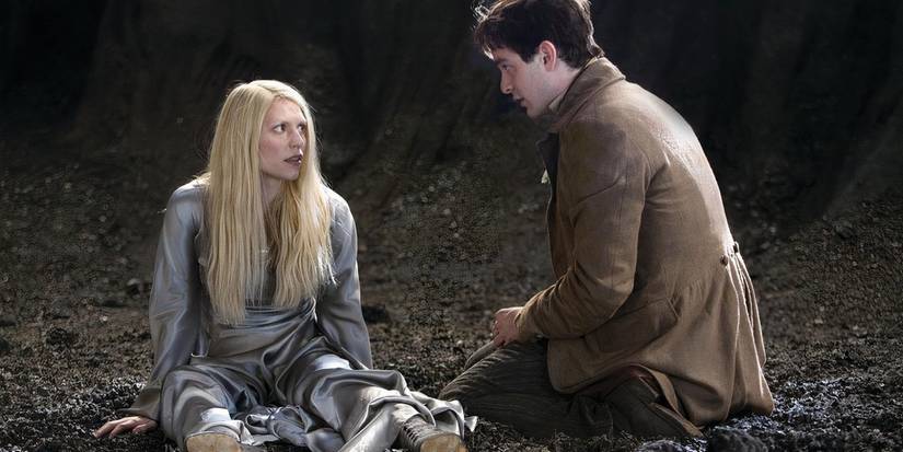 Yvaine (Claire Danes) in a silver dress with Tristan Thorn (Charlie Cox), both on the ground looking at each other skeptically in Stardust.