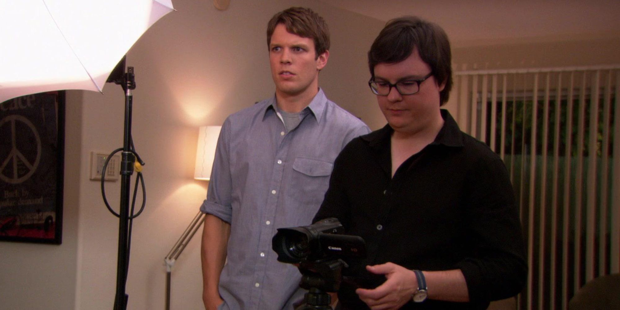 Clark filming something with Pete standing in the background in The Office