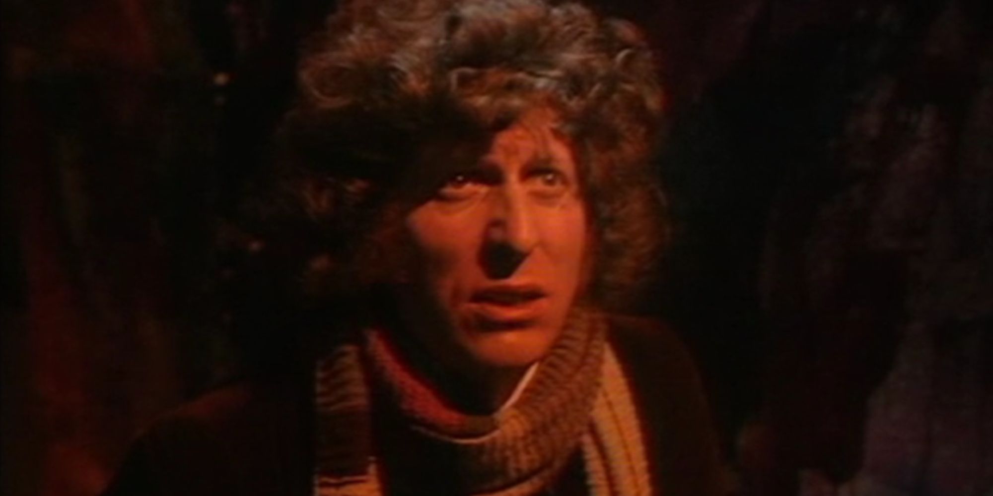 Tom Baker's Fourth Doctor looking afraid in Doctor Who