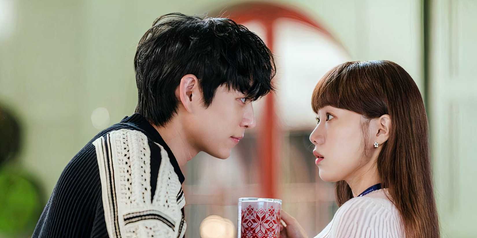 A man leans into the personal space of a woman who has a coffee cup in her hand in the k-drama Shooting Stars
